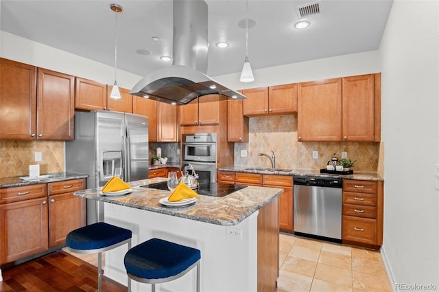 kitchen featuring decorative light fixtures, sink, island exhaust hood, and stainless steel appliances