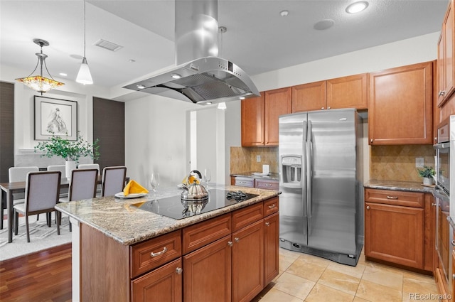 kitchen featuring a center island, black electric stovetop, stainless steel fridge, tasteful backsplash, and island exhaust hood