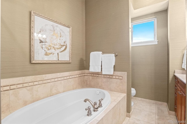 bathroom with tile patterned floors, tiled bath, vanity, and toilet