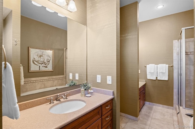 bathroom featuring tile patterned flooring, vanity, and walk in shower