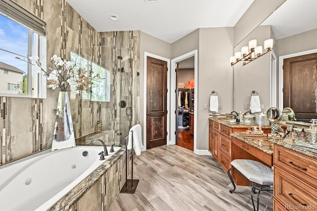7367 S Tempe Ct, Aurora, CO 80016 - full bath with a stall shower, a jetted tub, vanity, and a walk in closet