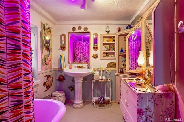 bathroom featuring a tub to relax in and a textured ceiling