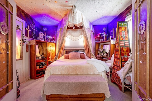 carpeted bedroom featuring a textured ceiling