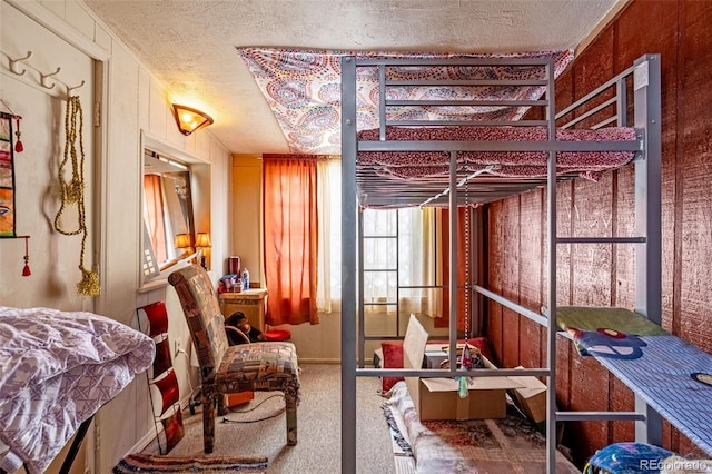 bedroom featuring carpet flooring and a textured ceiling