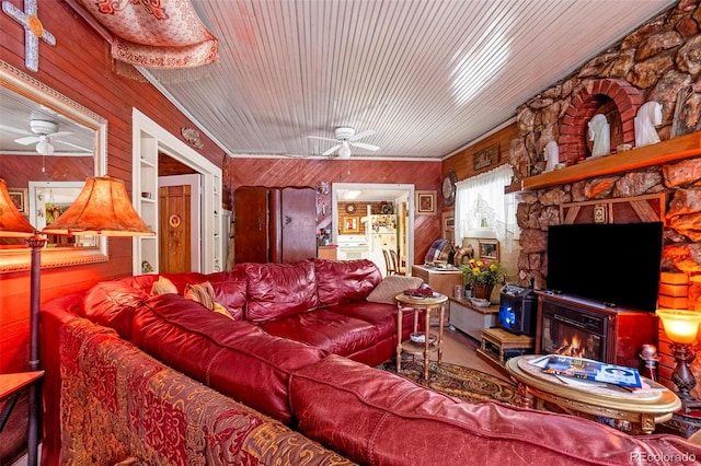 living room with wooden walls, wood ceiling, and ceiling fan