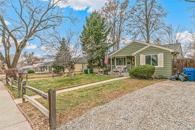 view of front of home featuring covered porch and a front lawn