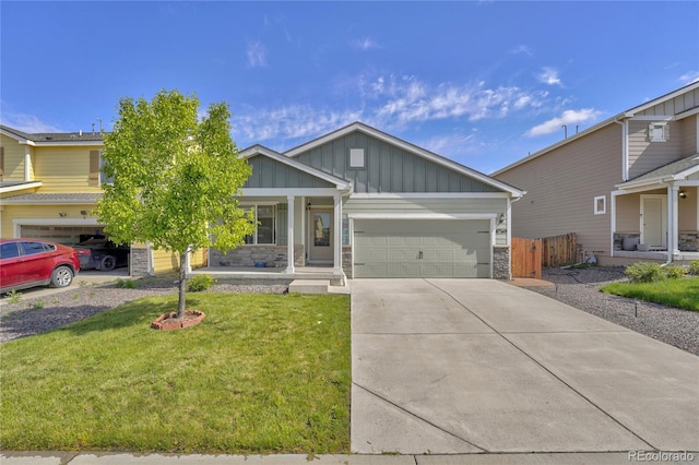 47349 Lily Ave, Bennett, CO 80102 - view of front of property with stone siding, board and batten siding, driveway, a porch, and a garage