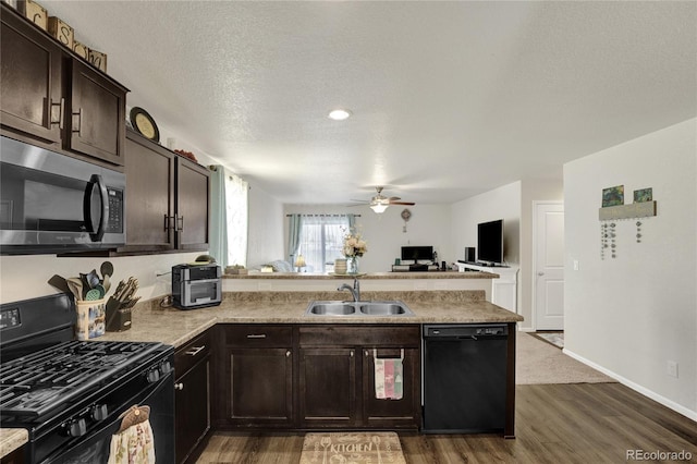 47349 Lily Ave, Bennett, CO 80102 - kitchen with black appliances, a sink, a peninsula, ceiling fan, and dark wood-style floors