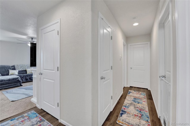 47349 Lily Ave, Bennett, CO 80102 - corridor with dark wood-style flooring, baseboards, and recessed lighting