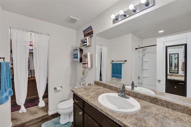 47349 Lily Ave, Bennett, CO 80102 - bathroom with toilet, vanity, wood finished floors, and baseboards