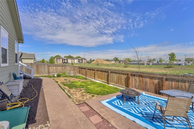 47349 Lily Ave, Bennett, CO 80102 - fenced backyard with an outdoor fire pit and a patio