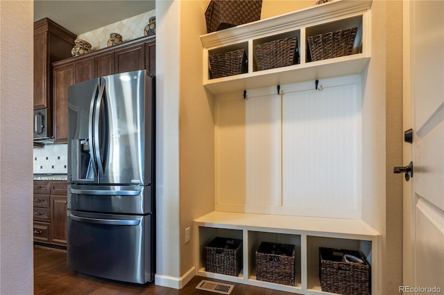 mudroom featuring dark wood-type flooring and visible vents