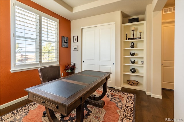 office space with dark wood-type flooring, visible vents, and baseboards