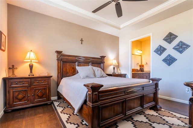 bedroom with connected bathroom, dark wood-type flooring, a ceiling fan, baseboards, and ornamental molding