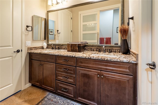 full bath with tile patterned floors, a sink, and double vanity