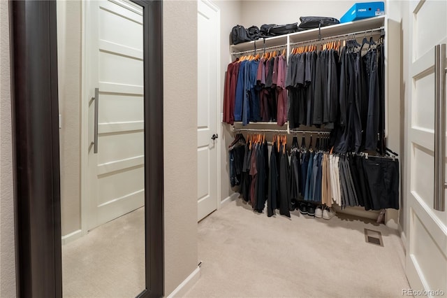 walk in closet with visible vents and carpet flooring