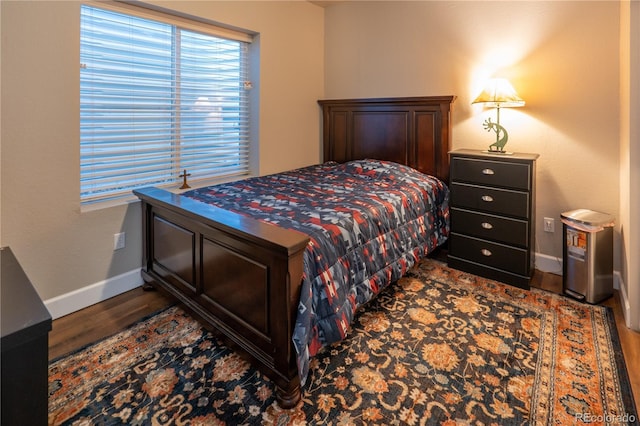 bedroom featuring dark wood-type flooring and baseboards