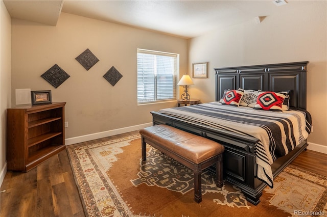 bedroom featuring wood finished floors and baseboards