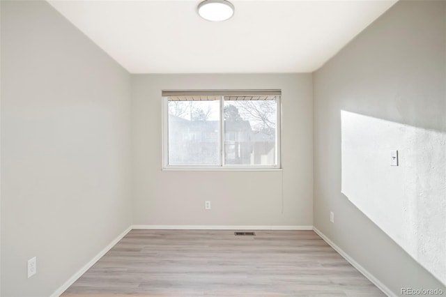 unfurnished room with visible vents, baseboards, and light wood-style floors