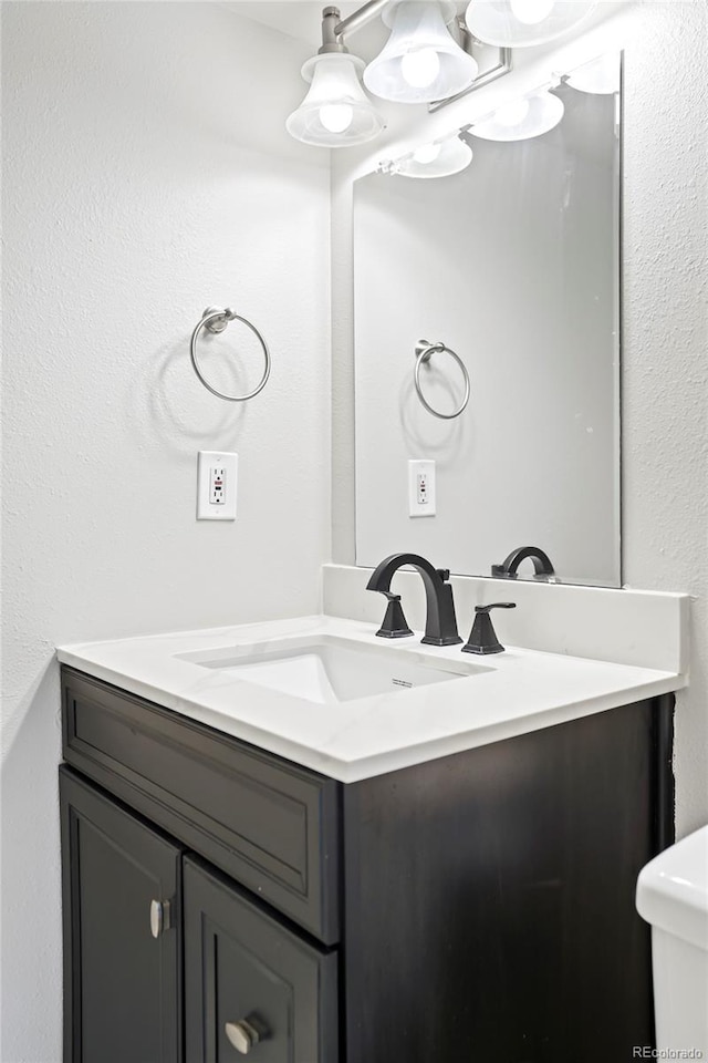 bathroom with vanity and an inviting chandelier