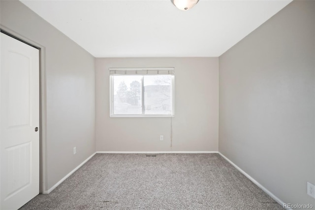 unfurnished room featuring baseboards and carpet flooring