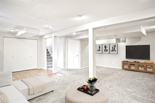 living room with baseboards, stairway, carpet floors, tile patterned floors, and a textured ceiling