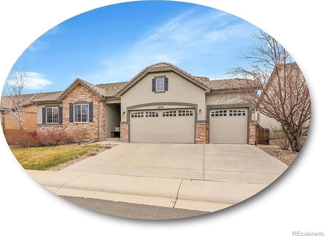 view of front of property with stucco siding, stone siding, concrete driveway, and an attached garage