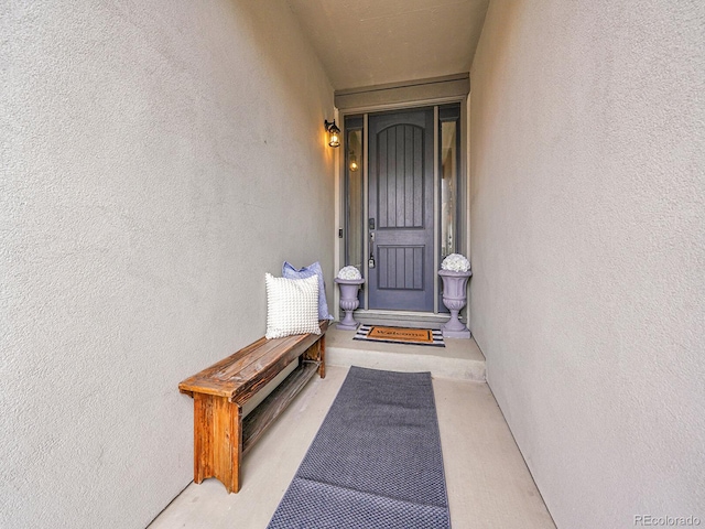 entrance to property with stucco siding