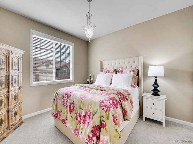 bedroom featuring carpet and baseboards