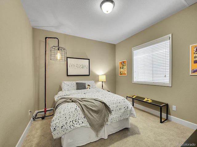 carpeted bedroom with baseboard heating and baseboards