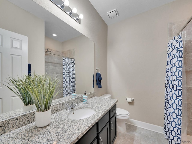 bathroom with vanity, baseboards, visible vents, a tile shower, and toilet