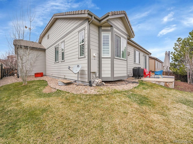 back of house with a yard, a patio area, and fence