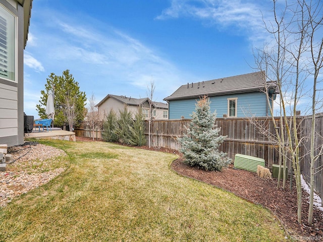 view of yard featuring a patio area and a fenced backyard