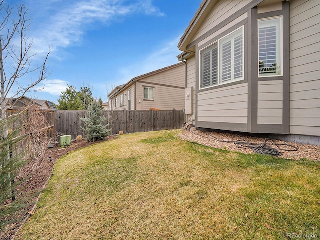 view of yard with central AC unit and a fenced backyard