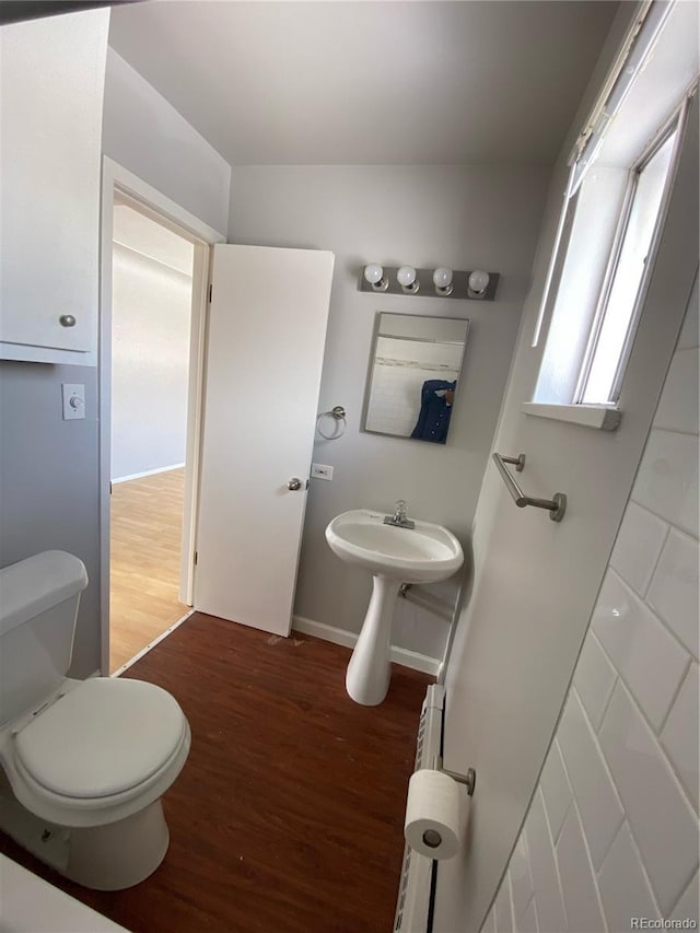 bathroom with wood-type flooring and toilet