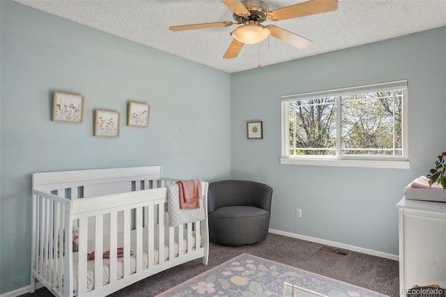 11446 W 105th Dr, Broomfield, CO 80021 - bedroom featuring ceiling fan, a textured ceiling, a nursery area, carpet floors, and baseboards
