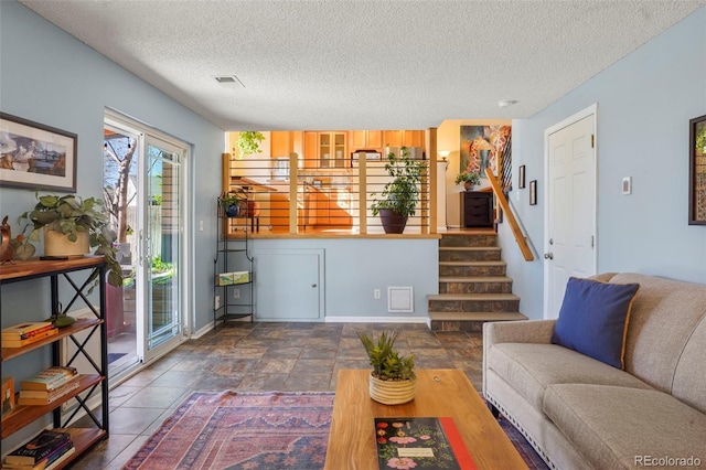 11446 W 105th Dr, Broomfield, CO 80021 - living area featuring stairs, a textured ceiling, and visible vents