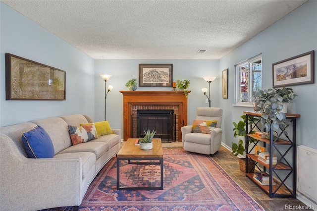 11446 W 105th Dr, Broomfield, CO 80021 - living room with visible vents, a textured ceiling, baseboards, and a fireplace