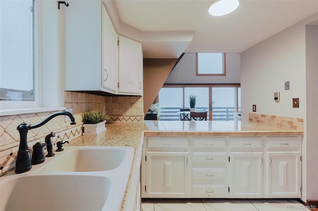 8691 S Warhawk Rd, Conifer, CO 80433 - kitchen with a sink, backsplash, and white cabinets