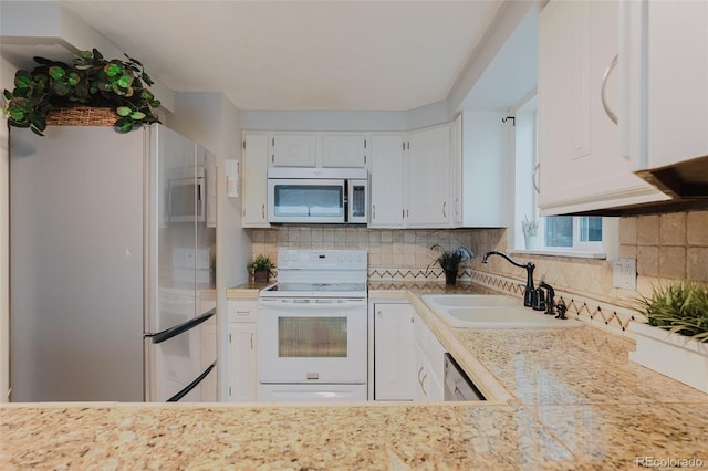 8691 S Warhawk Rd, Conifer, CO 80433 - kitchen featuring stainless steel appliances, a sink, light countertops, white cabinets, and tasteful backsplash