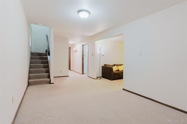 8691 S Warhawk Rd, Conifer, CO 80433 - spare room featuring light carpet, stairway, and baseboards