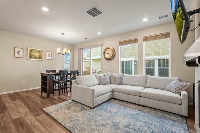 living room with a chandelier and wood-type flooring