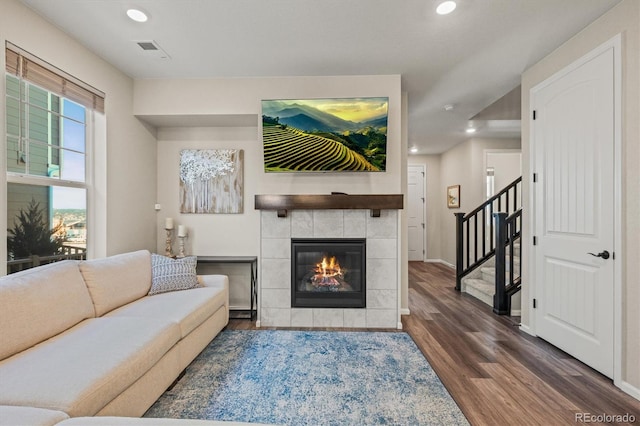 living room featuring a fireplace and dark hardwood / wood-style floors