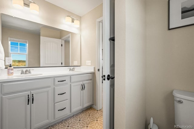 bathroom featuring toilet, vanity, and tile patterned flooring