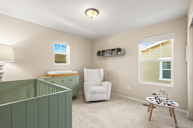 bedroom with a crib and light carpet