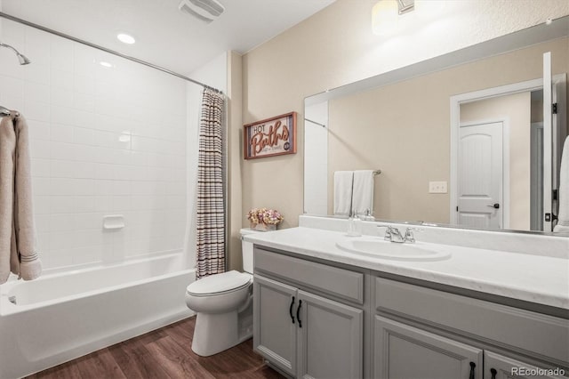 full bathroom with toilet, vanity, shower / bath combination with curtain, and hardwood / wood-style flooring