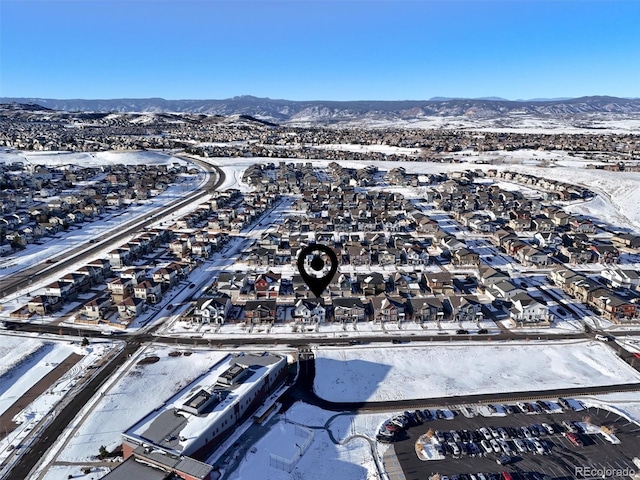 snowy aerial view with a mountain view