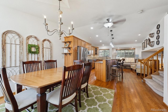 dining area with recessed lighting, stairway, wood finished floors, and ceiling fan with notable chandelier