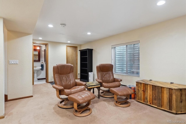 living area with recessed lighting, light colored carpet, and baseboards