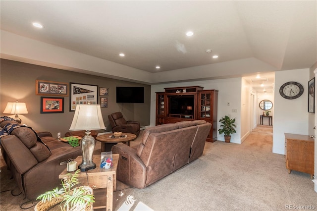 living room featuring a tray ceiling, light carpet, baseboards, and recessed lighting